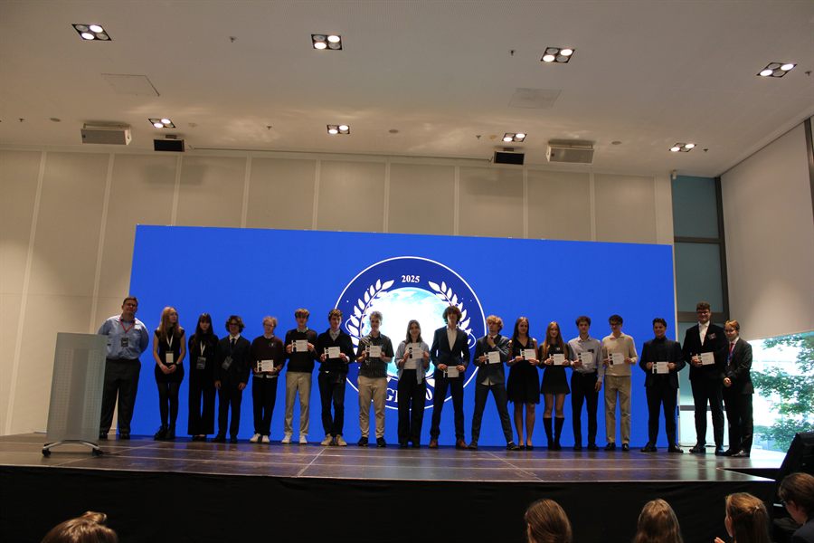 Delegates assembled on stage before the summit crest.