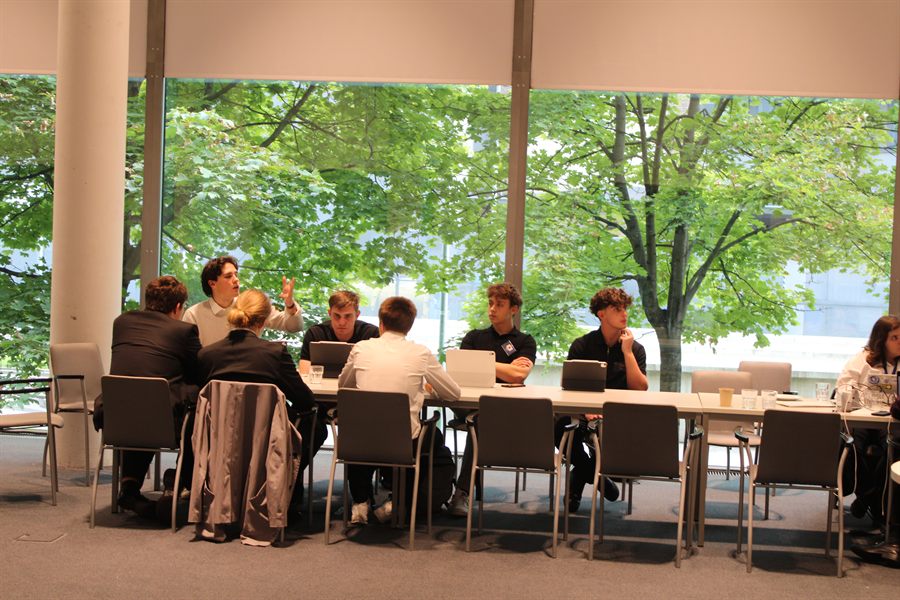 A committee in session beside the glass atrium.