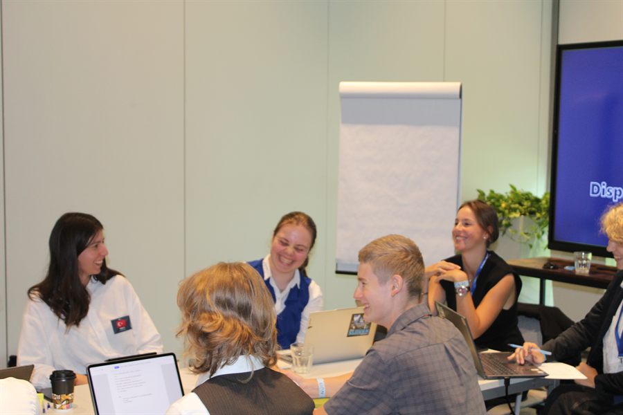 Delegates negotiating informally around a table.