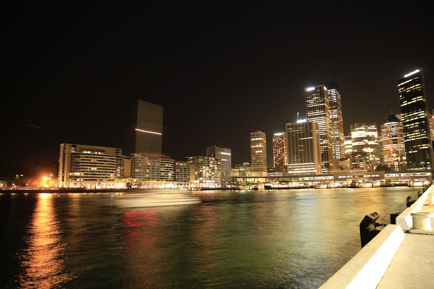 A financial district skyline across open water.
