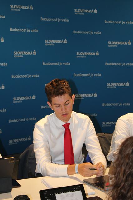 A delegate at the summit backdrop.