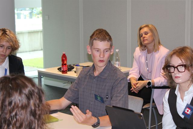 An advisor joins the discussion.
